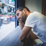 Man leaning on counter – shutterstock_388888915